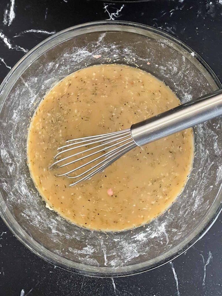 A gravy in a glass bowl for beef stroganoff.