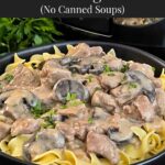 Slow Cooker Beef Stroganoff in a black bowl, garnished with chopped parsley.