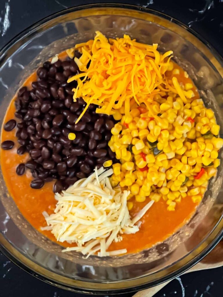 Chicken enchilada casserole ingredients together in a bowl.