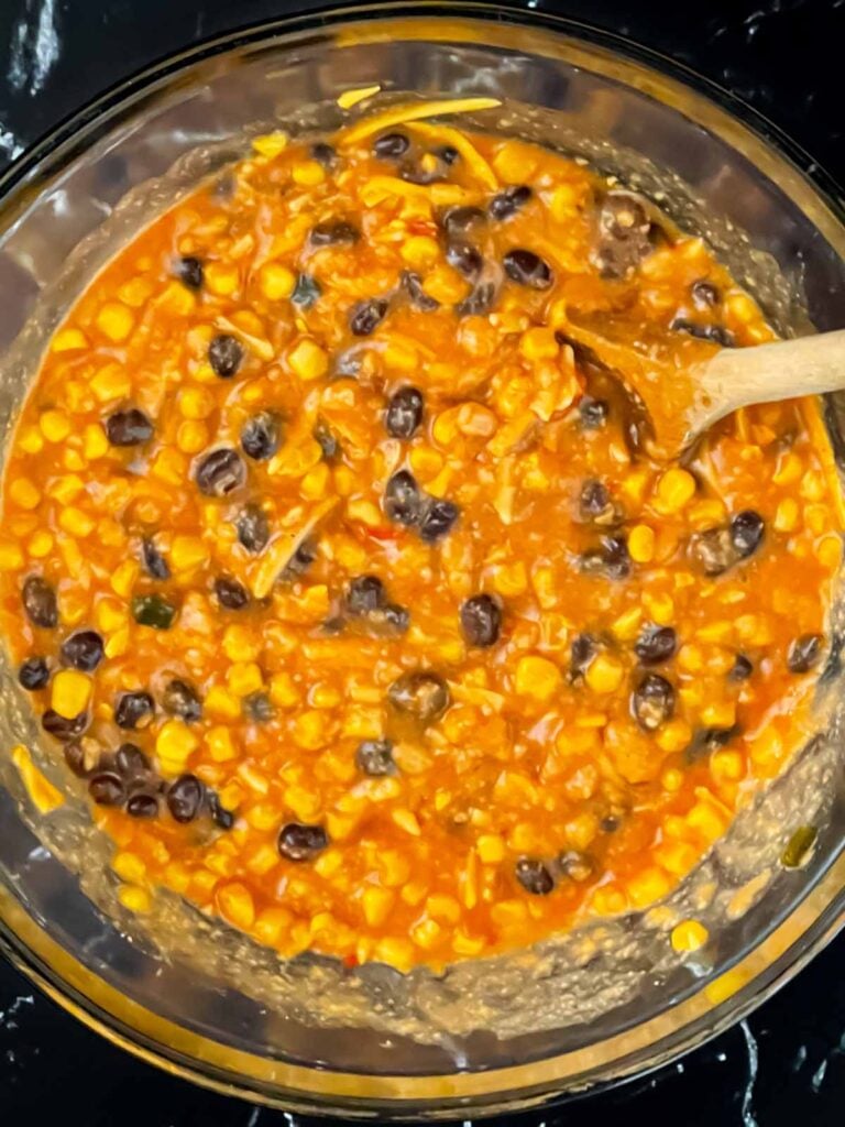 Chicken enchilada rice casserole ingredients together in a bowl.