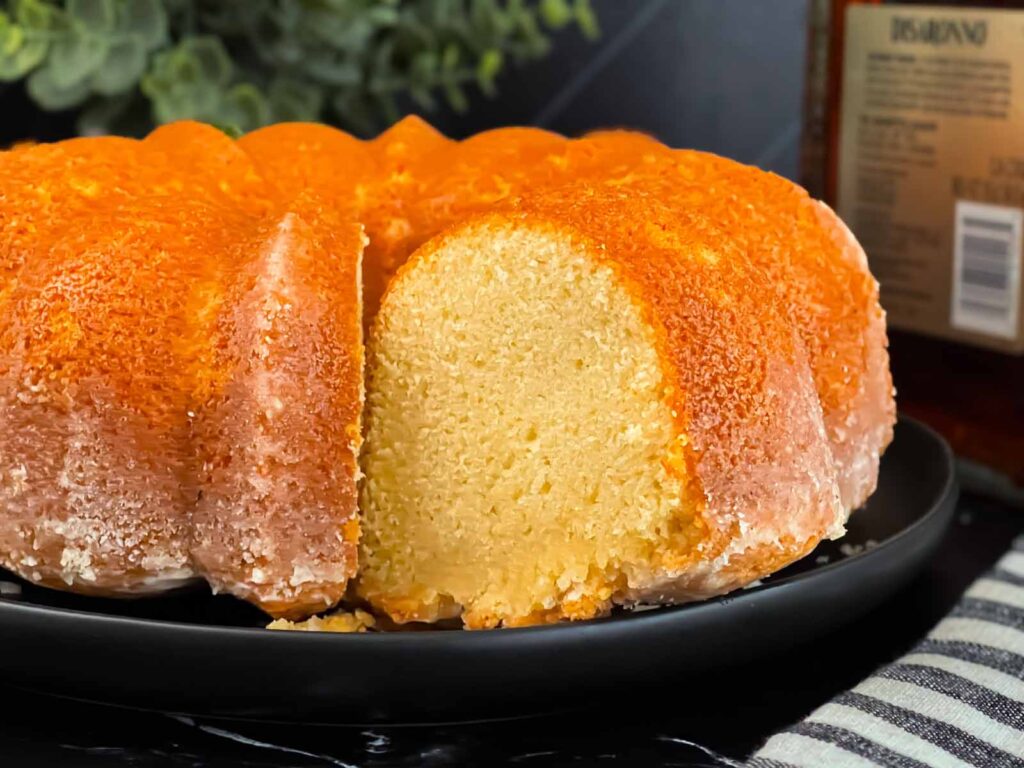 Amaretto pound cake on a black plate.